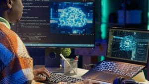 AI for Data Analytics & BI. Coder using AI software on computer. Data science, machine learning, and business intelligence.