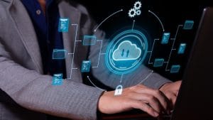 AWS Cloud Practitioner: Person using laptop with cloud computing graphic overlay.