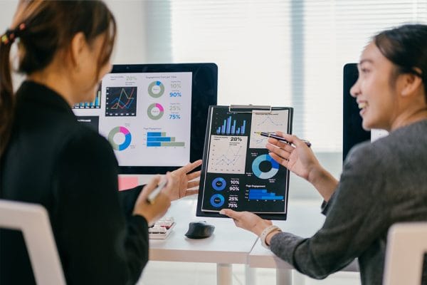 Data for Decision-Makers: Businesswomen analyze charts and graphs. Data-driven decisions.