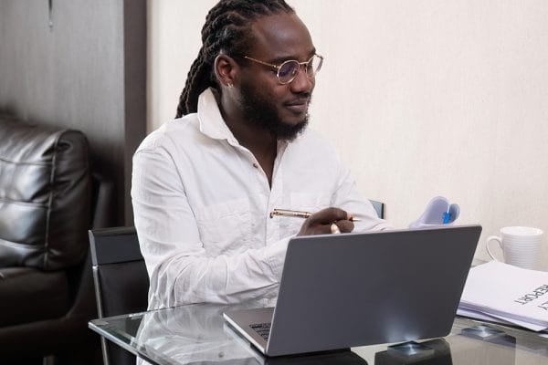 Go Programming Essentials: Man with laptop studying Go. Learn Go programming language. Online Go course.