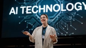 AI technology presentation. Woman presenting machine learning models on stage.