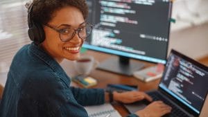 Woman coding Python on laptop. Pythonista to Python Master. Programming, development, software engineer.