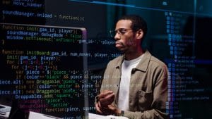 Systems engineer working on code. Man with glasses coding. Software development. Systems Engineering Journey.