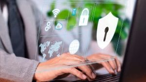 Certified Information Security Manager (CISM). Data security concept with shield, padlock, and world map icons on a laptop.