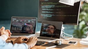 Data analyst to data scientist: Coding on multiple screens. Data science, programming, analytics.