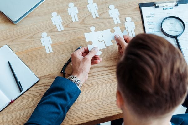 Human Resources Consultant connecting puzzle pieces. Recruitment, resume, and hiring concept.