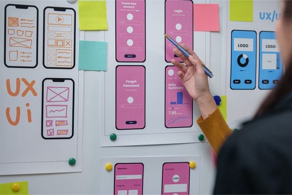 Mobile development: UX/UI designer working on app wireframes and user interface design.