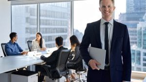 Leadership skills builder: Businessman with team in a modern office. Business meeting, leadership training.