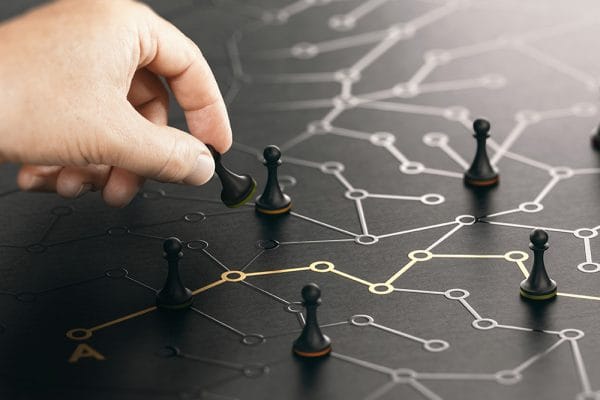 Strategic thinking concept. Hand moving chess pawn on network, planning business strategy.