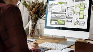 Web development basics. Designer working on website wireframe. Computer screen with website design.