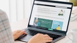 WordPress: Person using laptop. Screen displays Free Coronavirus Design Resources website.