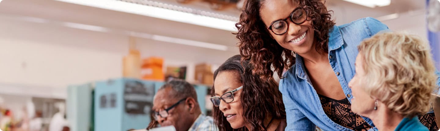 Adult education training: Diverse group learning together, smiling. Lifelong learning.